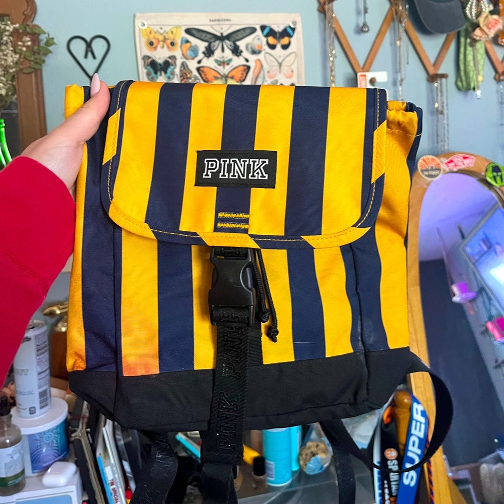 PINK small backpack. Striped yellow and navy blue with think adjustable straps.
